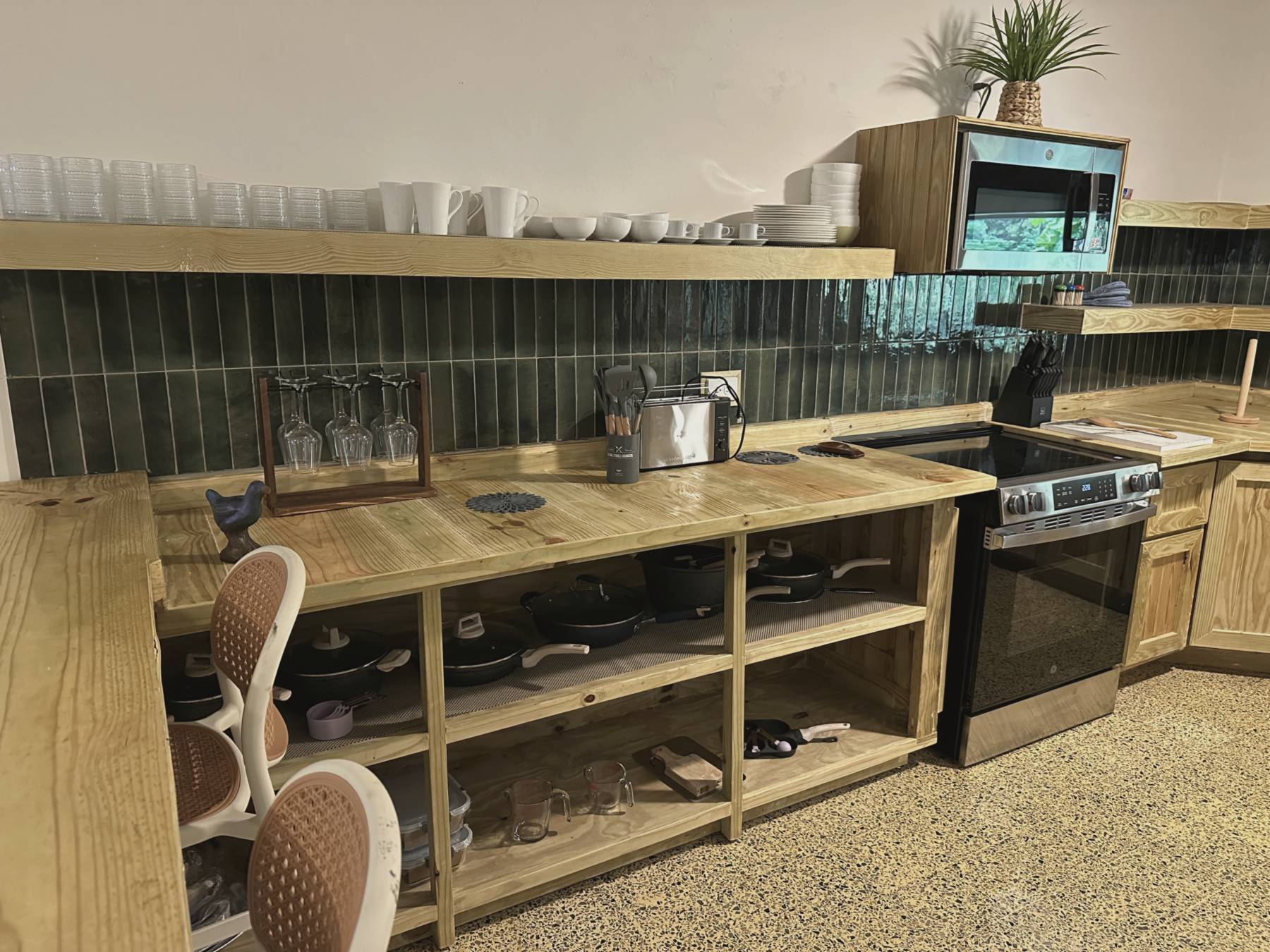 Casa Yuké fully-equipped kitchen with green-tile backsplash