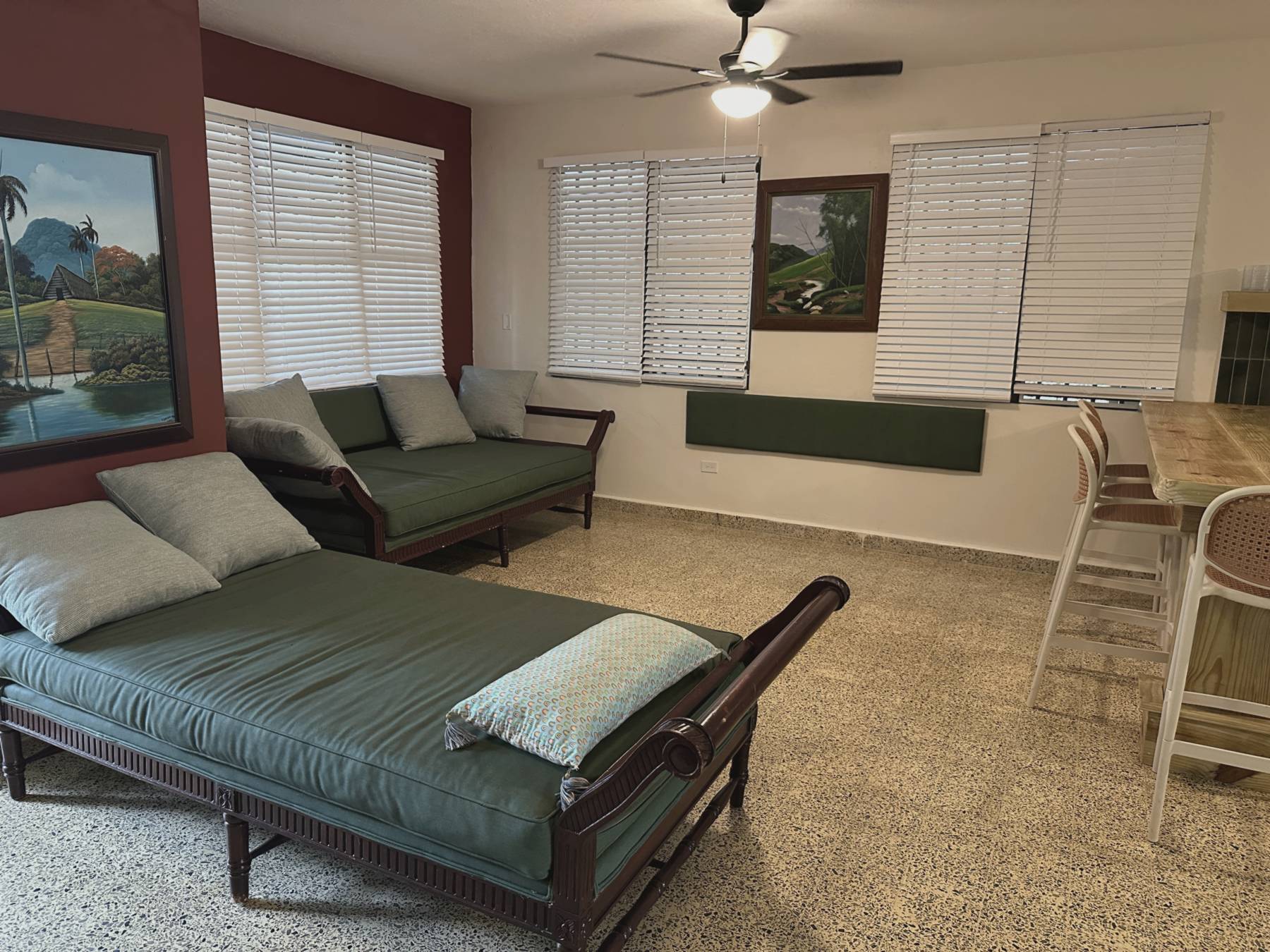 Casa Yuké living room with carved daybeds and local artwork